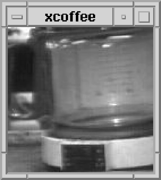 A small greyscale webcam image of a glass coffee jug on a warmer, inside a plain 1990s window frame labelled xcoffee.
